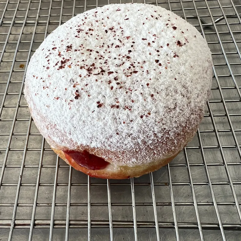 Brioche donut filled with strawberry-sumac jam and dusted with sumac